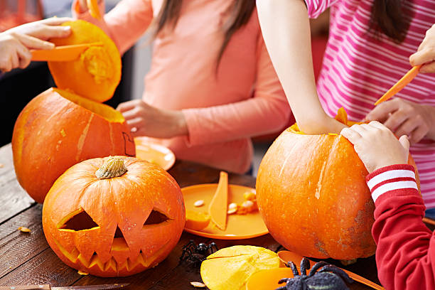 bambini che fanno decorazione di zucca di halloween per le persone - gourd halloween fall holidays and celebrations foto e immagini stock