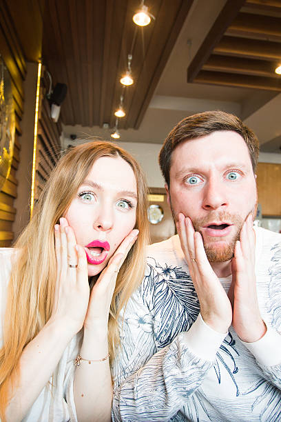 istock Pretty funny cheerful couple showing surprise 589117866