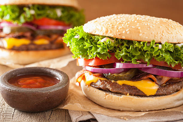 istock bacon cheese burger with pickles tomato onion 589118352