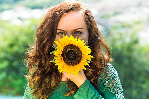 istock beautiful woman with sunflower 589118906