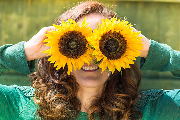 istock beautiful woman with sunflower 589119010