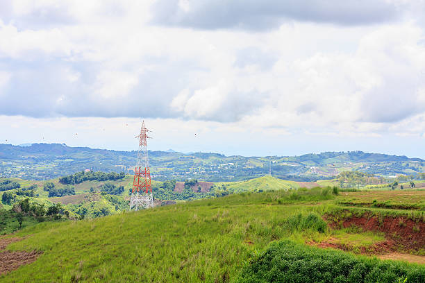 istock High voltage power lines tower on green mountain 589119174