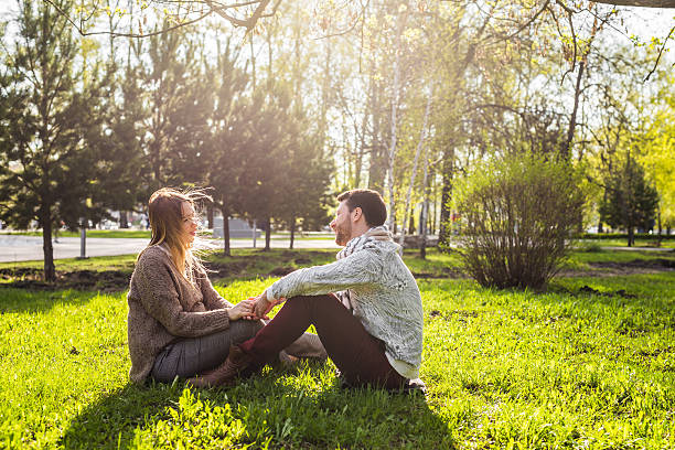 istock Romantic young couple in love relaxing outdoors in park 589119442