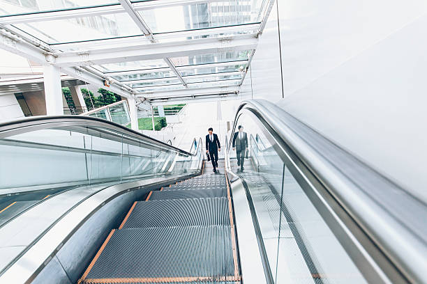 istock Businessman moving up on escalator 589121994