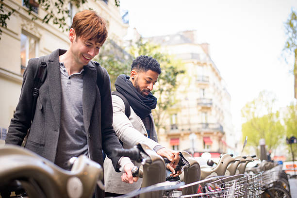 A young man on a bicycle rests while talking on the phone in a street near the Champs-Elysées in Paris.