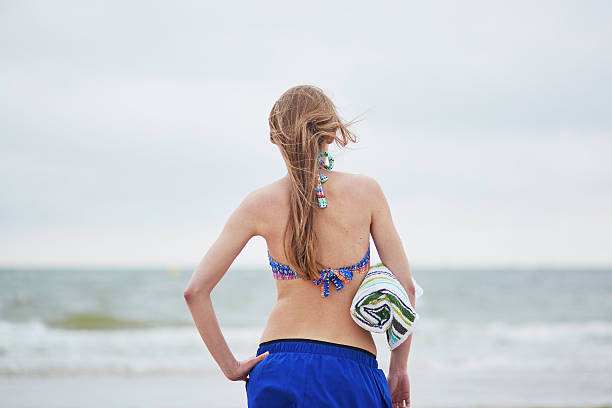 istock Woman relaxing and sunbathing on sand beach 589122808