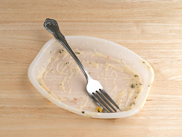 istock Finished TV dinner with fork on a wood table 589125350