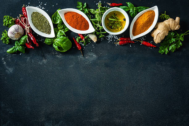 istock Herbs and spices over black stone background 589125642