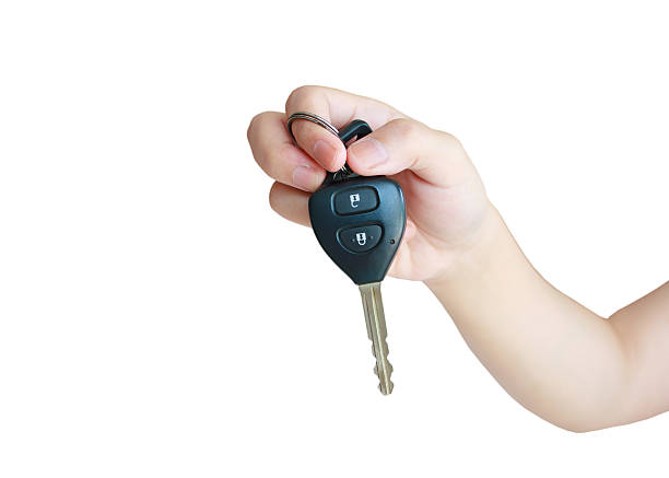 istock Hand holding car key isolated on white background 589126538