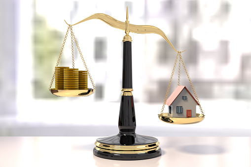 3D rendering of classic scales of justice with stacks of coins and a house, inbalance scale