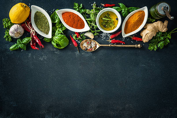 istock Herbs and spices over black stone background 589127098