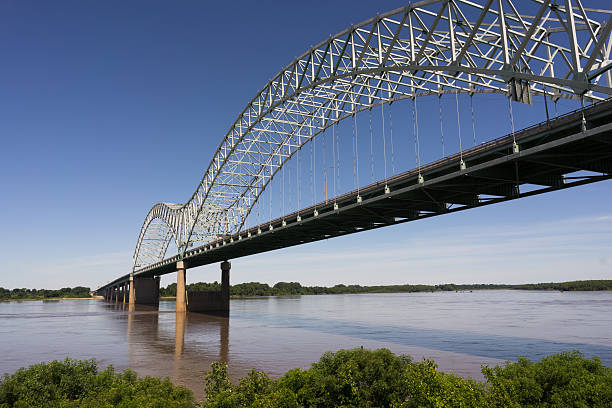 Hernando de Soto Bridge Spanning Mississippi River Arkansas Tennessee The Mississippi River flows under the Hernando de Soto Bridge looking towards Arkansas memphis tennessee stock pictures, royalty-free photos & images