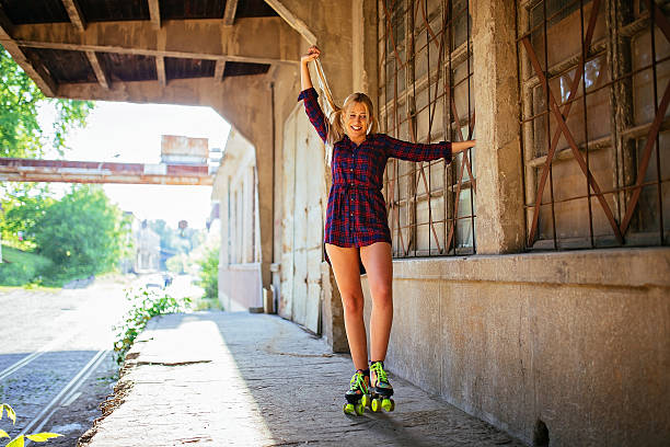 istock Young woman posing on the rollerskates 589127808