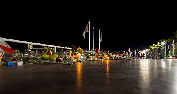 Nice, France Terrorist Attack Promenade Memorial Nice, France - August 7, 2016: Candles and flowers at the temporary memorial on the Promenade des Anglais in Nice a few weeks after the terrorist attached. Showing the aftermath of the Nice terrorist attack on 14 July 2016. A truck was deliberately driven into crowds on the Promenade des Anglais resulting in the death of 85 people and injuring 307. islamic state stock pictures, royalty-free photos & images