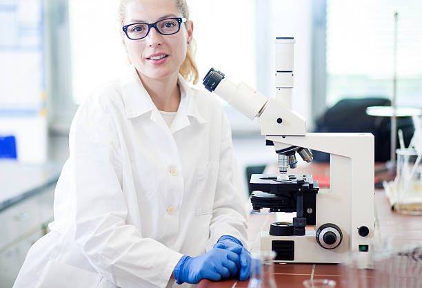 istock Portrait of a Scientist Beside the Microscope 589128366