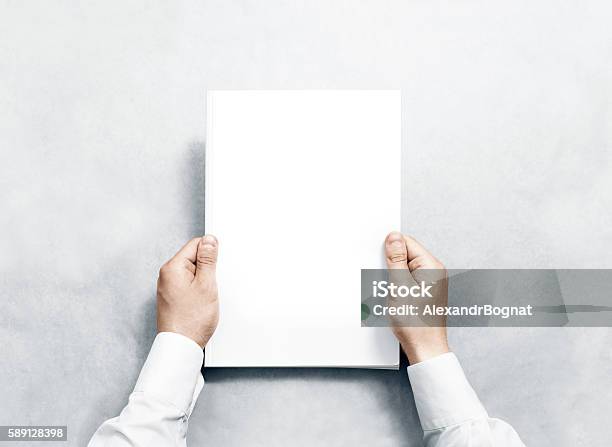 Hand Holding White Journal With Blank Cover Mockup Stock Photo - Download Image Now