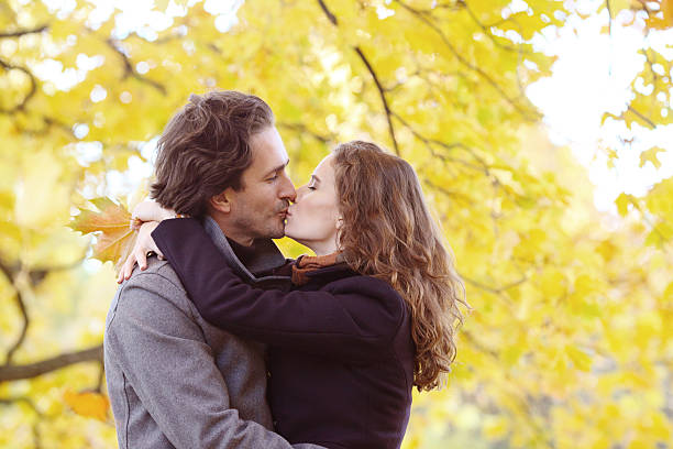 istock Couple kissing in autumn park 589129100