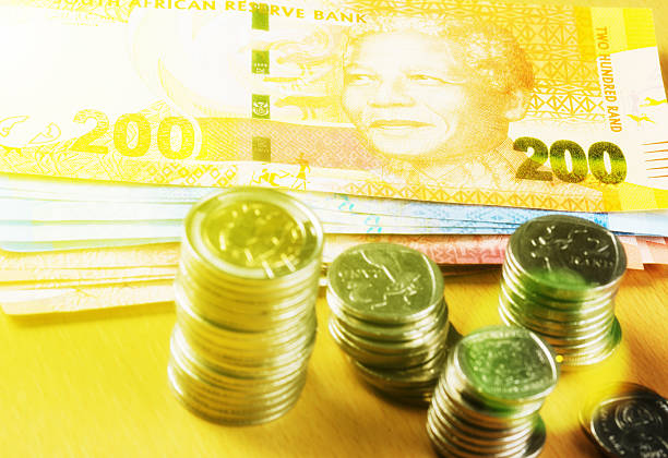istock South African currency in soft-focus golden light 589129462