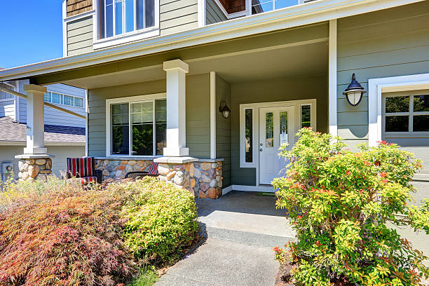 istock Covered porch with white columns and stone trim. 589130192