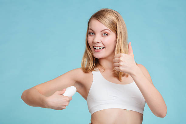 istock Girl applying stick deodorant in armpit. 589130428