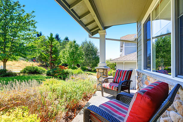 istock Covered porch with white columns and stone trim. 589130448