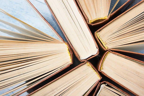 istock Open book, hardback books on wooden table. Back to school 589131586