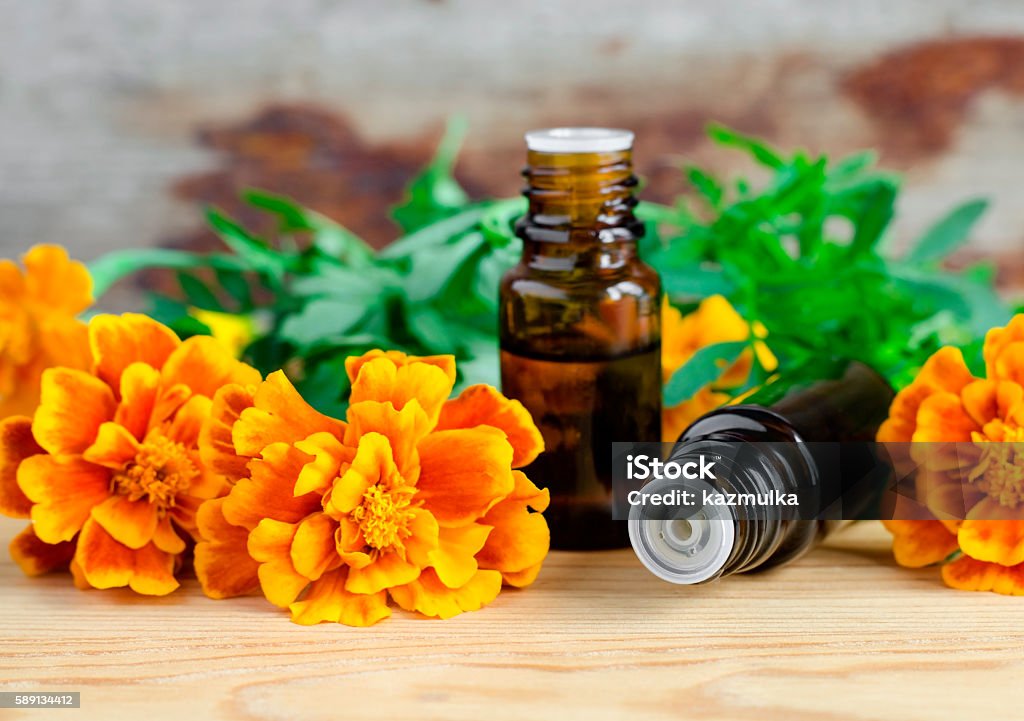 Two small bottles of essential marigold oil Two small bottles of essential marigold oil (Tagetes flowers extract, tincture, infusion) Acne Stock Photo