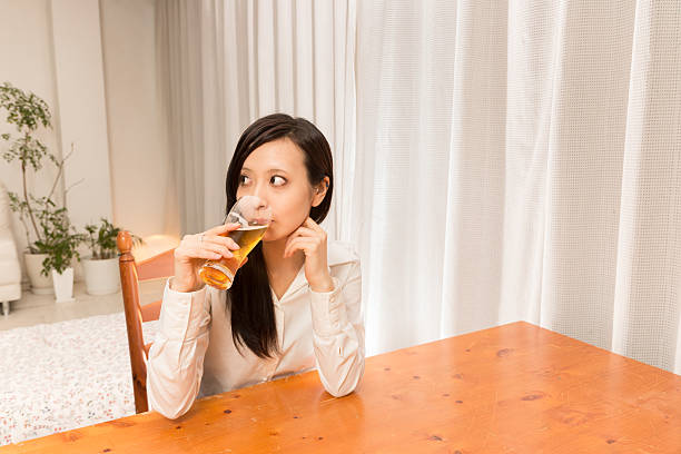 istock woman who drinks beer at home 589135150
