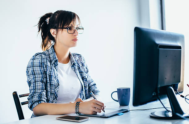 istock Young female designer working at the office 589416776