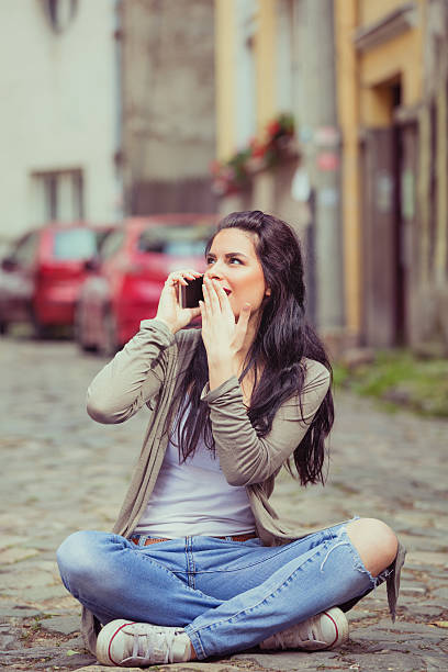 istock Girl using cellphone outdoors. 589417256