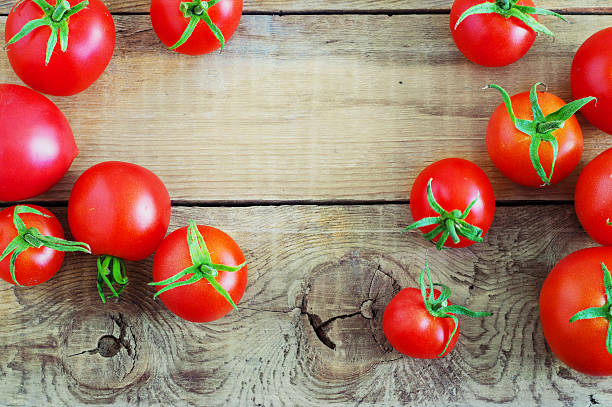 istock tomatoes on wooden background 589419112