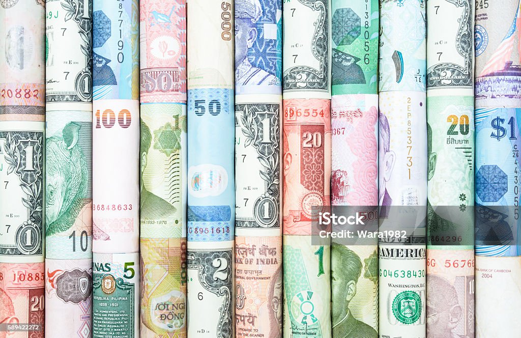 Many Currency A backgrounds with colorful of many roll curreny from many country Currency Stock Photo