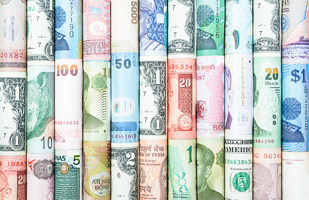 Many Currency A backgrounds with colorful of many roll curreny from many country currency paper currency capital wealth stock pictures, royalty-free photos & images