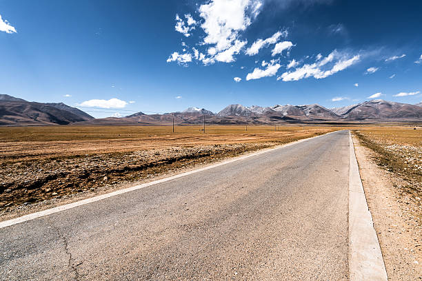 istock Long road leading towards mountains 589422800