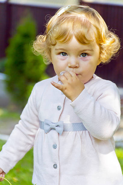 istock Cute infant with curly blond hair 589422912