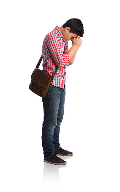istock Side view of student praying with head down 589423320