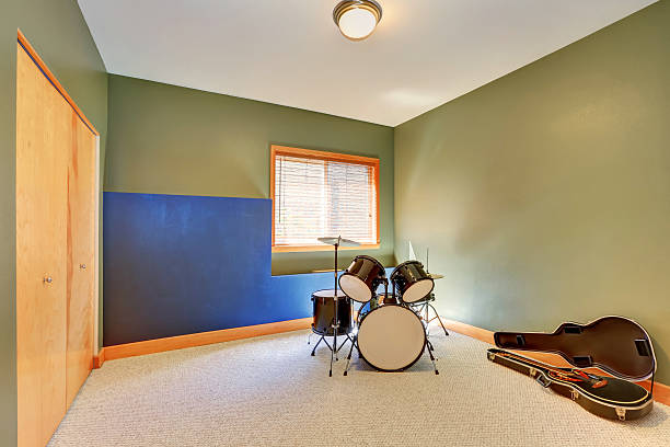 Rehearsal room with drums and guitar.