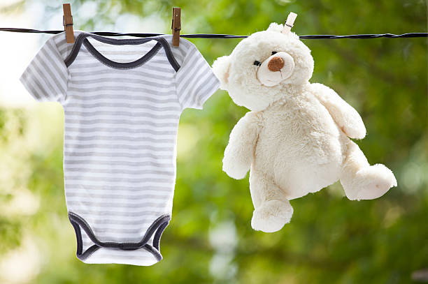 istock Baby clothes and teddy bear hanging on the clothesline 589423556