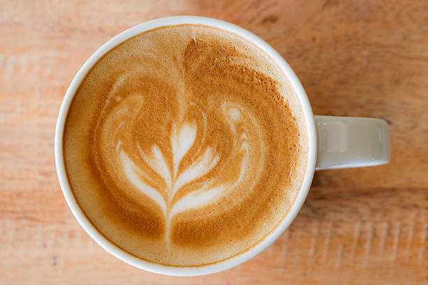 istock Coffee in white cup on wood table in coffee shop. 589423842
