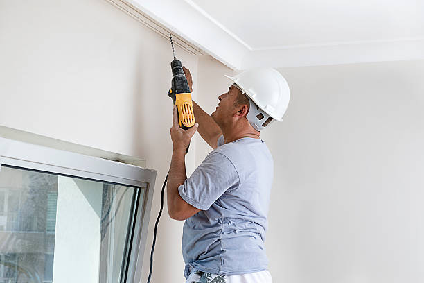 Worker Drilling Ceiling Manual worker drilling hole in ceiling for curtain rail.     curtain rail stock pictures, royalty-free photos & images