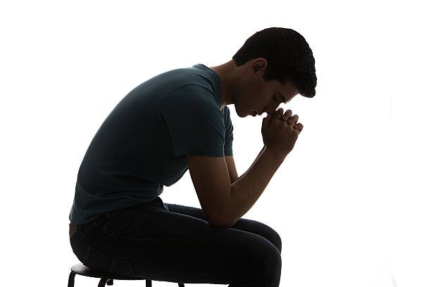 Praying hands. Prayer to God. Catholic or Christian man. Faith, religion and belief. Help and hope from Bible and church. Worship Jesus. Meditation or forgiveness for sin. Spiritual religious person.