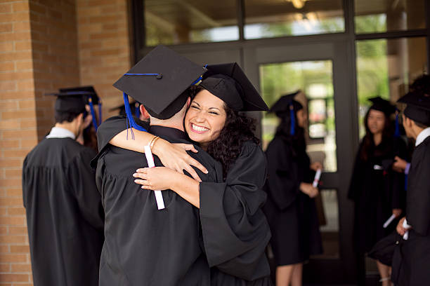 istock Good friends embrace after graduating together 589426044