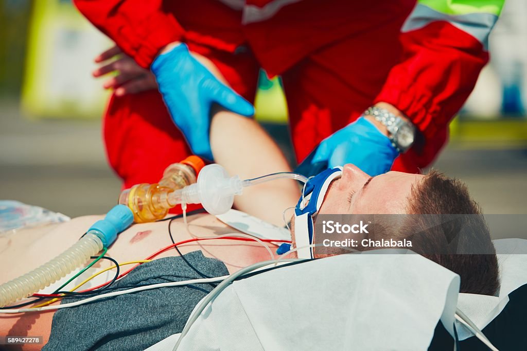 Emergency medical service Paramedic preparing the patient after resuscitation for transport to the hospital. Ambulance Stock Photo