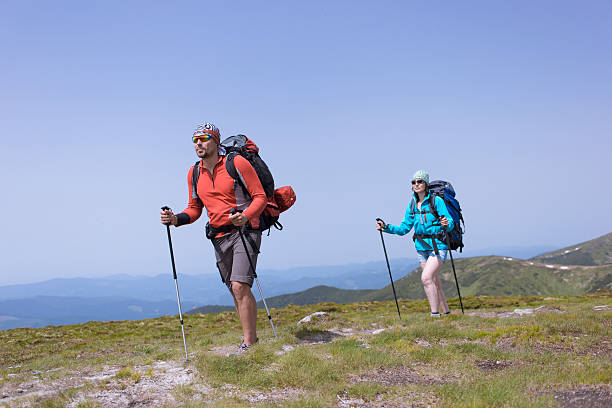 istock Summer hiking in the mountains with a backpack and tent. 589431806