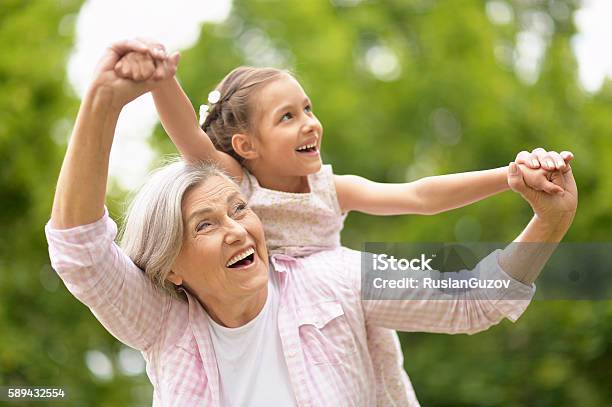 Grandmother With Granddaughter In Park Stock Photo - Download Image Now - Child, Grandmother, Senior Women