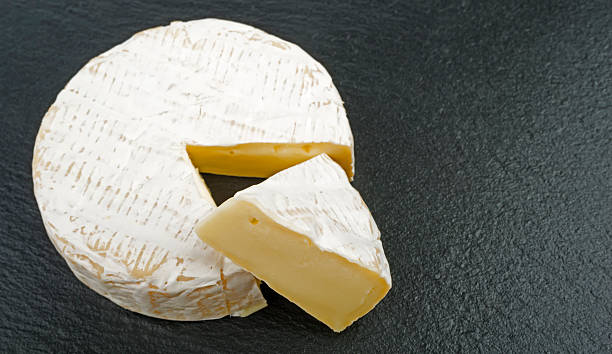 istock french cheese - round camembert with cut slice 589433934