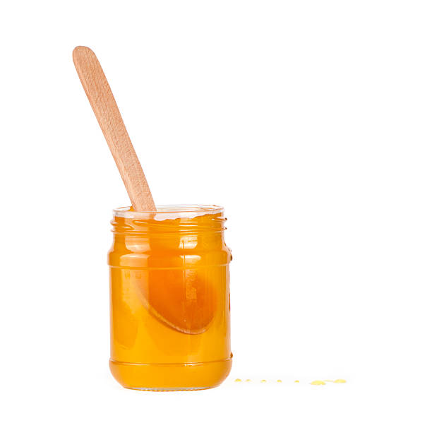 istock Jar of honey and  honey dipper 589434652