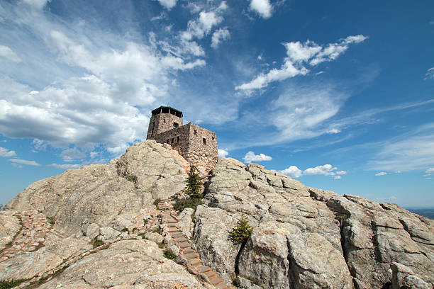 istock Harney Peak Fire Lookout Tower under cirrus cumulus clouds 589435104