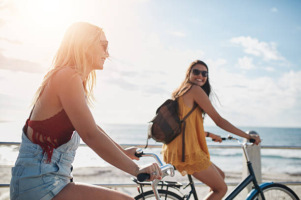 istock Two women going by bike on sunny day 589435916