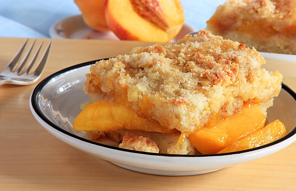 Peach cobbler Southern United States treat overflowing with the fresh fruit of the season cobbler dessert stock pictures, royalty-free photos & images